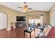 Comfortable living room featuring a ceiling fan, hardwood floors, and sliding glass doors at 12925 Fieldmoor Ct, Riverview, FL 33579