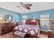 Inviting bedroom with light blue walls, a ceiling fan, and large windows at 12925 Fieldmoor Ct, Riverview, FL 33579