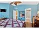 Spacious bedroom featuring wood floors, ensuite bath, and views into the dining and living area at 12925 Fieldmoor Ct, Riverview, FL 33579