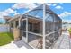 Screened in patio with seating and an attached house with a view of the yard and sky at 12925 Fieldmoor Ct, Riverview, FL 33579