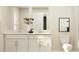 Modern bathroom featuring double sinks, a toilet, and a large mirror at 13518 White Gold Run, Parrish, FL 34219