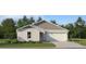 Charming single-story home with a two-car garage and beautifully landscaped front yard at 14974 Topaz Blue St, Wimauma, FL 33598