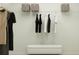 Organized walk-in closet offering hanging storage, shelving, and a bench at 14984 Topaz Blue St, Wimauma, FL 33598