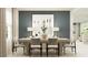 Bright dining room with a large wooden table, comfortable seating, and contemporary decor provides an inviting space at 14984 Topaz Blue St, Wimauma, FL 33598