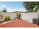 A fenced backyard featuring a wood deck and foliage against a clear blue sky, creating a private outdoor retreat at 16076 Dawnview Dr, Tampa, FL 33624