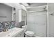 Modern bathroom with a glass-enclosed shower, mosaic tile, and floating vanity at 16076 Dawnview Dr, Tampa, FL 33624
