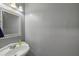 Powder room featuring a pedestal sink, decorative mirror, and modern faucet fixture at 16076 Dawnview Dr, Tampa, FL 33624