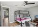 Cozy bedroom featuring a bunk bed, ceiling fan, and ample natural light at 16076 Dawnview Dr, Tampa, FL 33624