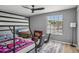 Bedroom with bunk bed, ceiling fan and a view of the outside at 16076 Dawnview Dr, Tampa, FL 33624