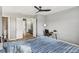 Bedroom with ceiling fan, hardwood floors, and walk-in closets, providing ample storage at 16076 Dawnview Dr, Tampa, FL 33624