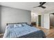 Comfortable bedroom featuring hardwood floors, ceiling fan, and ensuite bathroom at 16076 Dawnview Dr, Tampa, FL 33624