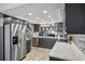 A modern kitchen with stainless steel appliances, light countertops, and dark wood cabinetry at 16076 Dawnview Dr, Tampa, FL 33624