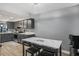 Charming kitchen features gray cabinets, a mosaic backsplash and a marble breakfast table at 16076 Dawnview Dr, Tampa, FL 33624