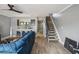 Open concept living room featuring wood floors, stairs, and a view of the kitchen at 16076 Dawnview Dr, Tampa, FL 33624
