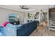 Stylish living room with large blue sofa, flat-screen TV, and modern decor at 16076 Dawnview Dr, Tampa, FL 33624