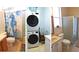 Functional bathroom featuring a washing machine and dryer, a walk in shower, and a neutral color palette at 16515 Nikki Ln, Odessa, FL 33556