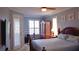 Well-lit bedroom with a king bed, ample windows, and a TV mounted on the wall for your relaxing enjoyment at 16515 Nikki Ln, Odessa, FL 33556