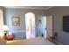 Cozy bedroom with an ensuite bathroom, a TV on the wall, and soft blue colored walls to promote relaxation at 16515 Nikki Ln, Odessa, FL 33556
