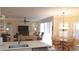 Inviting living room with tile flooring and an adjacent dining area with a chandelier at 16515 Nikki Ln, Odessa, FL 33556