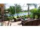 Screened-in patio with scenic lake views, ample seating, and a water feature perfect for outdoor relaxation at 16515 Nikki Ln, Odessa, FL 33556