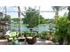 Screened lanai with comfortable seating and a view of the lake and fountain at 16515 Nikki Ln, Odessa, FL 33556