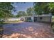 Spacious backyard featuring a brick patio, well-maintained landscaping, and a privacy fence at 1766 Hitching Post Ln, Dunedin, FL 34698