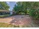Spacious backyard with a charming brick patio and fire pit at 1766 Hitching Post Ln, Dunedin, FL 34698