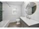 Modern bathroom with white subway tile, blue accent wall, and gray vanity at 1766 Hitching Post Ln, Dunedin, FL 34698