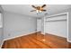 Bright bedroom with hardwood floors, ceiling fan, and a spacious closet at 1766 Hitching Post Ln, Dunedin, FL 34698