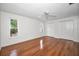 Bedroom featuring gleaming hardwood floors, white walls and natural light at 1766 Hitching Post Ln, Dunedin, FL 34698