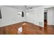 Bedroom featuring hardwood flooring, a ceiling fan, and a large closet at 1766 Hitching Post Ln, Dunedin, FL 34698