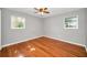 Cozy bedroom with hardwood floors, natural lighting, and ceiling fan at 1766 Hitching Post Ln, Dunedin, FL 34698