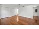 Bedroom with gleaming hardwood floors and bright white walls with closets at 1766 Hitching Post Ln, Dunedin, FL 34698