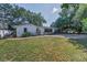 Charming home with well-manicured landscaping, a brick driveway, and a screened-in porch at 1766 Hitching Post Ln, Dunedin, FL 34698