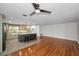 Open kitchen and living area with a gray island with seating, contrasting backsplash, and updated appliances at 1766 Hitching Post Ln, Dunedin, FL 34698