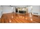Open-concept living area featuring hardwood floors, recessed lighting, and seamless flow to the kitchen at 1766 Hitching Post Ln, Dunedin, FL 34698