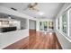 Spacious living room flows openly to the kitchen and sunroom that leads to the outdoors at 1766 Hitching Post Ln, Dunedin, FL 34698