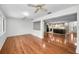 Open living space featuring hardwood floors that flows seamlessly to the kitchen and breakfast bar seating at 1766 Hitching Post Ln, Dunedin, FL 34698