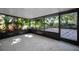 Screened-in patio with lush greenery views, ideal for relaxation and entertainment at 1766 Hitching Post Ln, Dunedin, FL 34698