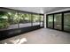 Spacious screened-in patio with access to a brick-paved backyard at 1766 Hitching Post Ln, Dunedin, FL 34698