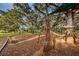 Modern playground featuring rope climbs and slides, set amongst large shade trees at 1766 Hitching Post Ln, Dunedin, FL 34698