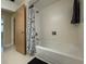 Bathroom features a tub and shower with black and white patterned shower curtain at 1775 62Nd S Ter, St Petersburg, FL 33712