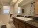 Bathroom featuring a solid surface vanity, updated faucet, tub with shower, and a large mirror at 1775 62Nd S Ter, St Petersburg, FL 33712