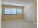 Neutral bedroom featuring a window with blinds, and a large closet with bi-fold doors at 1775 62Nd S Ter, St Petersburg, FL 33712