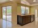 Kitchen with wooden cabinetry, a large window, and access to an outdoor patio area for relaxing at 1775 62Nd S Ter, St Petersburg, FL 33712