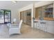 A patio with lots of seating adjacent to an indoor bar area at 1775 62Nd S Ter, St Petersburg, FL 33712