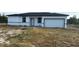 Exterior of a newly constructed single-story home featuring an attached garage at 19233 Wilton Ave, Port Charlotte, FL 33954