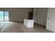 Bright unfinished living area with big sliding glass doors and an island at 19233 Wilton Ave, Port Charlotte, FL 33954