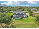 Aerial view of a home with a screened-in pool and a spacious, grassy backyard at 19803 Prince Benjamin Dr, Lutz, FL 33549