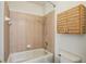 Bathroom featuring tiled shower and tub combination, and convenient wall storage at 19803 Prince Benjamin Dr, Lutz, FL 33549